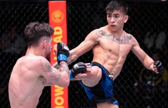  Mario Bautista kicks Jay Perrin in their bantamweight fight during the UFC Fight Night event at UFC APEX on February 19, 2022 in Las Vegas, Nevada. (Photo by Jeff Bottari/Zuffa LLC)