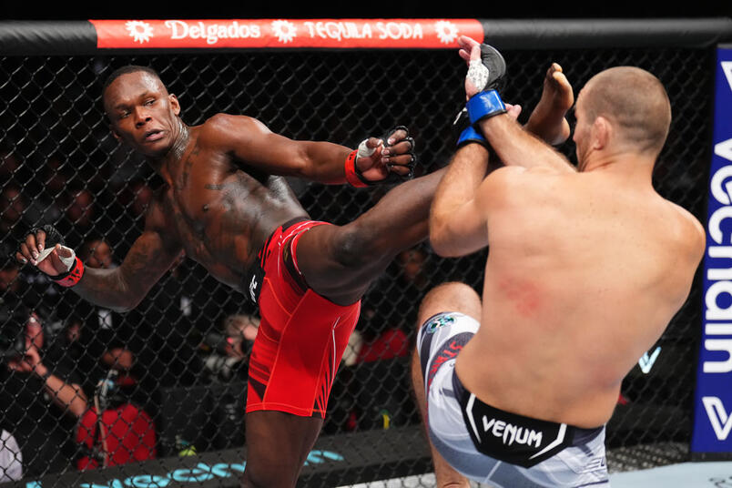 Israel Adesanya of Nigeria kicks Sean Strickland in the UFC middleweight championship fight during the UFC 293 event at Qudos Bank Arena on September 10, 2023 in Sydney, Australia. (Photo by Chris Unger/Zuffa LLC)